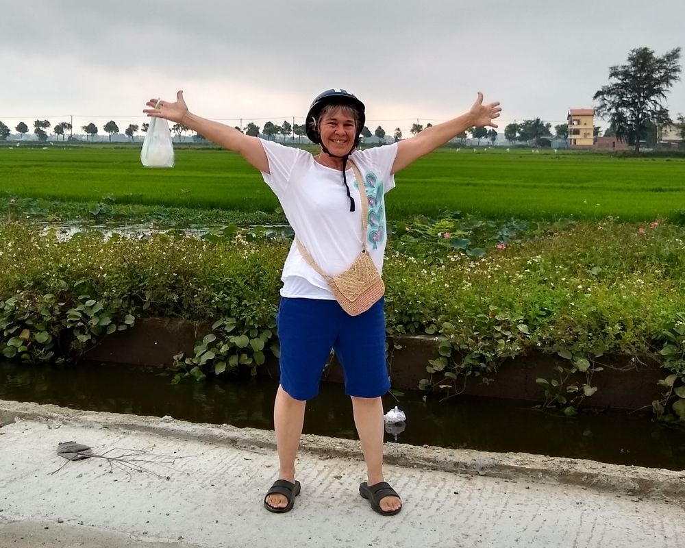 Michelle with arms outstretched very happy to be in Vietnam