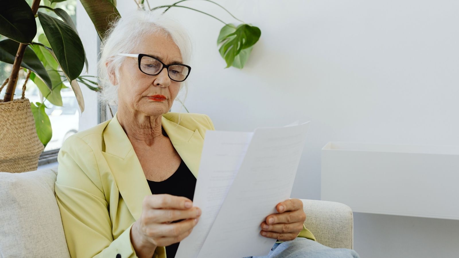 Older woman reviewing documents while planning a move abroad